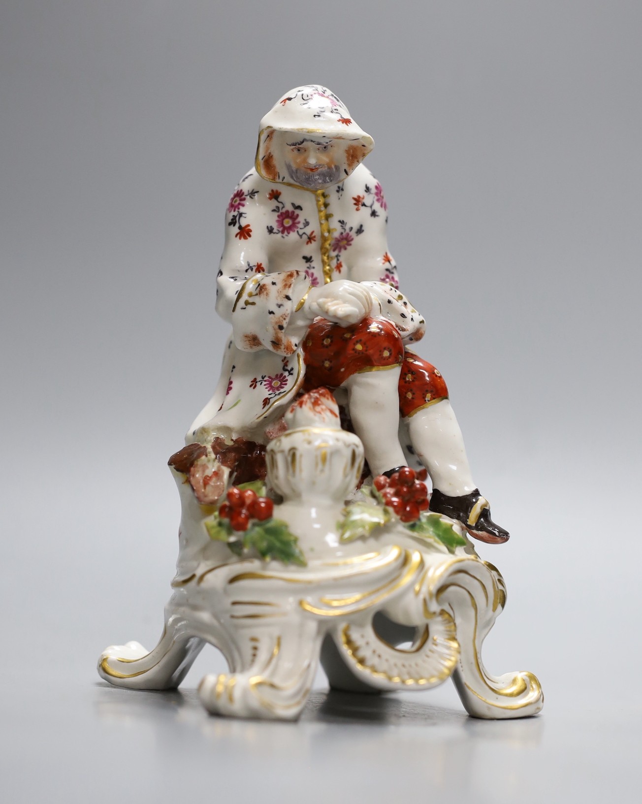 A Bow figure of Winter on a scroll moulded base painted with flowers, having an anchor dagger mark in red, 16.5 cms high